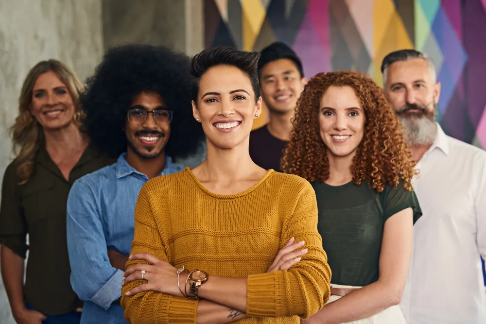 Diverse team standing together and smiling