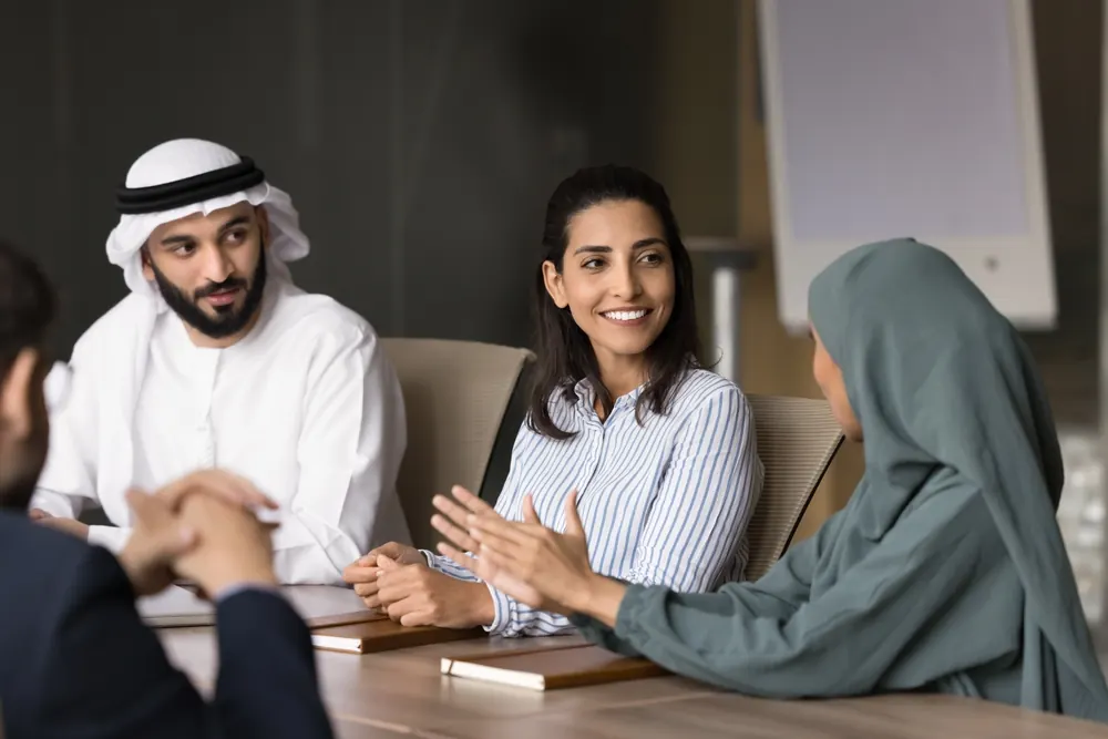 Advisors meeting a client across a table