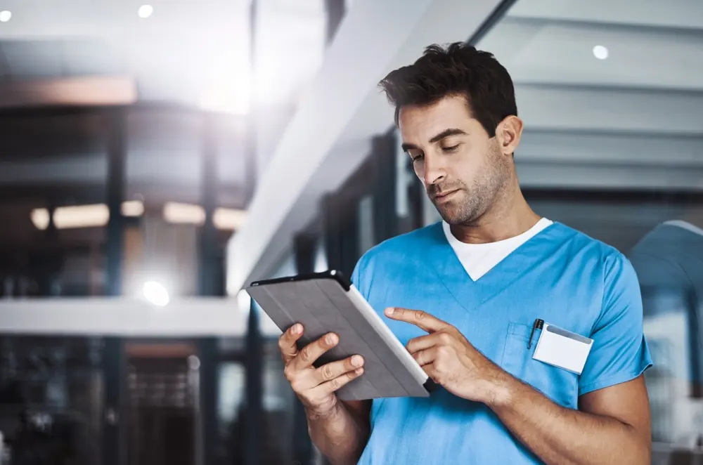 Clinician using a tablet in a hospital