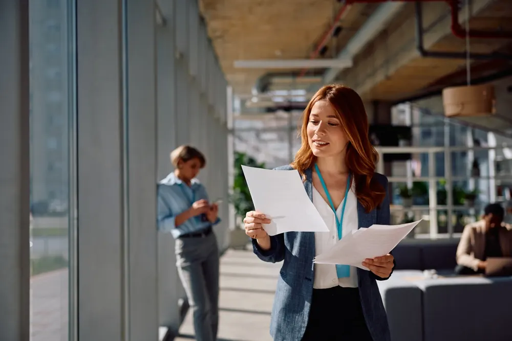 Professional reviewing paperwork in an office